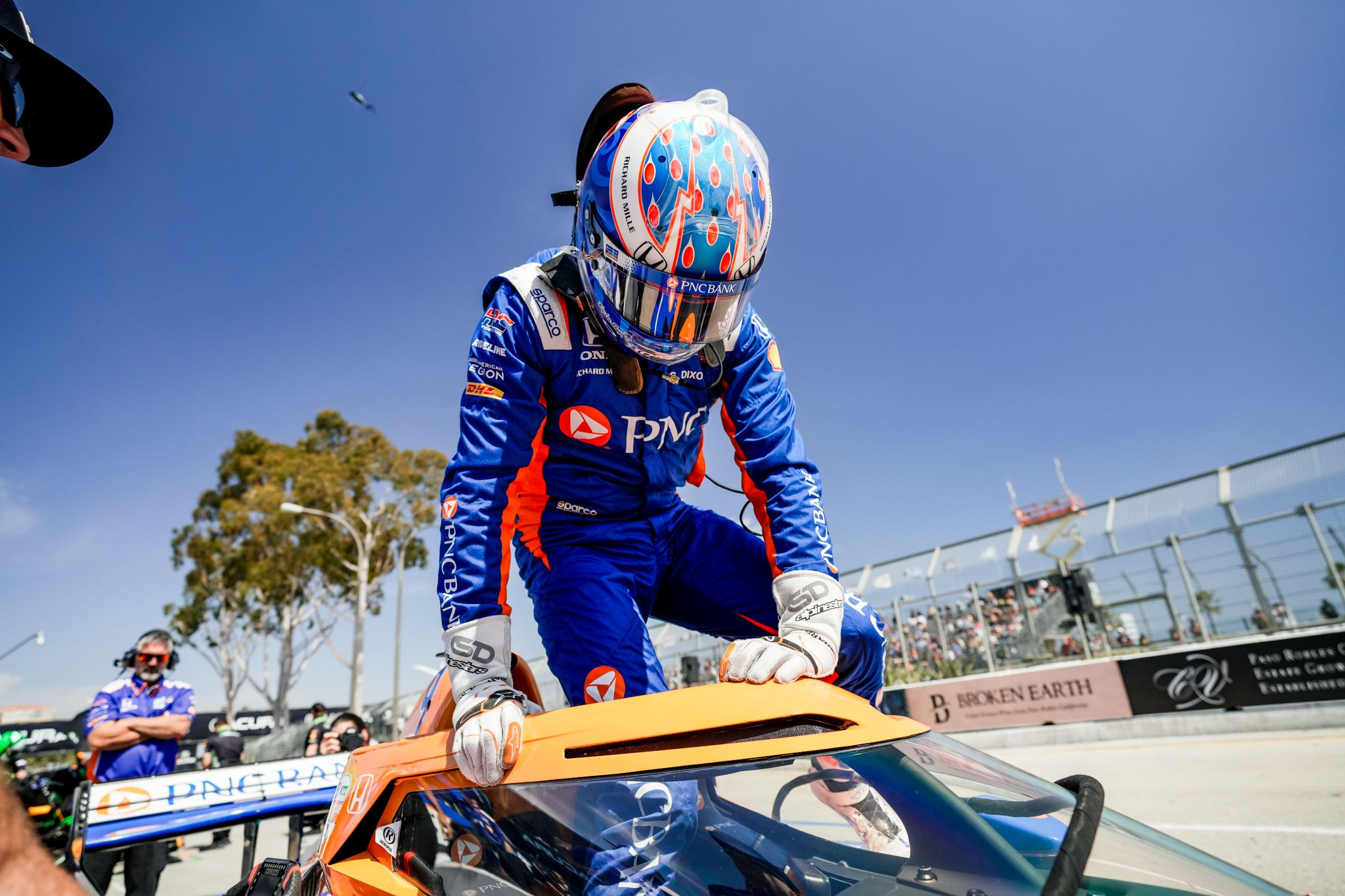 Scott Dixon climbs into his race car on race day.