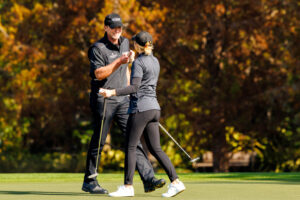 Steve Stricker fist bumps his daughter Izzi during the PNC Championship.